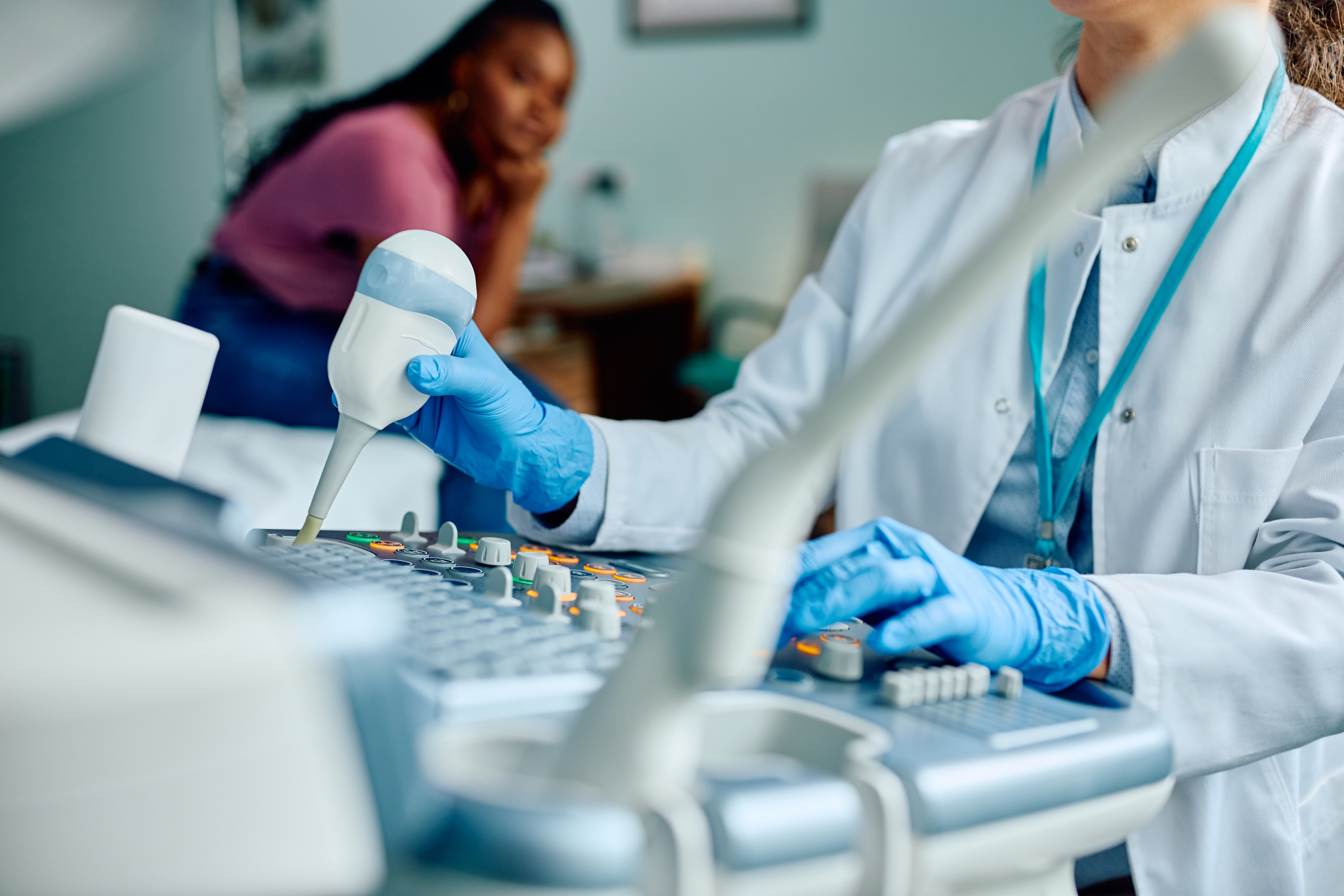 Close up of doctor using ultrasound in medical examination room
